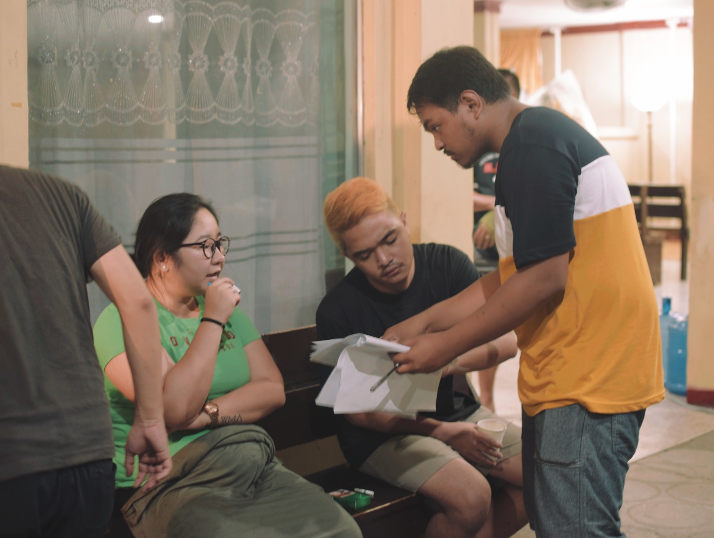 director explains script to actors